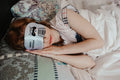 Signature Comfuurt Silk Sleep Mask - Woman resting with sleep mask