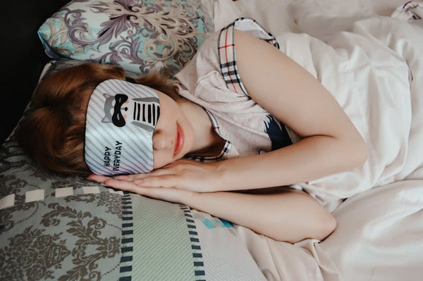 Signature Comfuurt Silk Sleep Mask - Woman resting with sleep mask